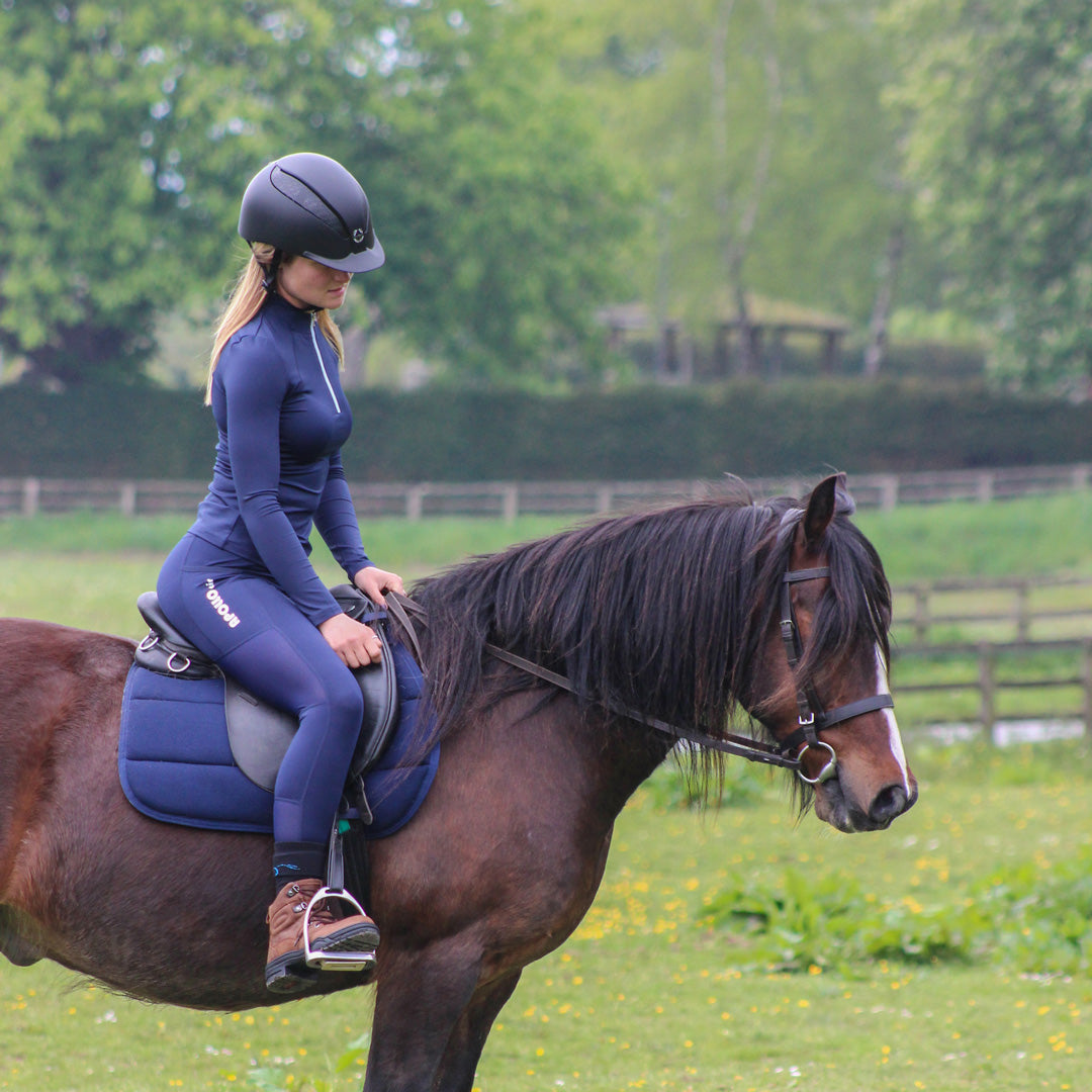 Side view of rider wearing the Cameo Equine technical baselayer