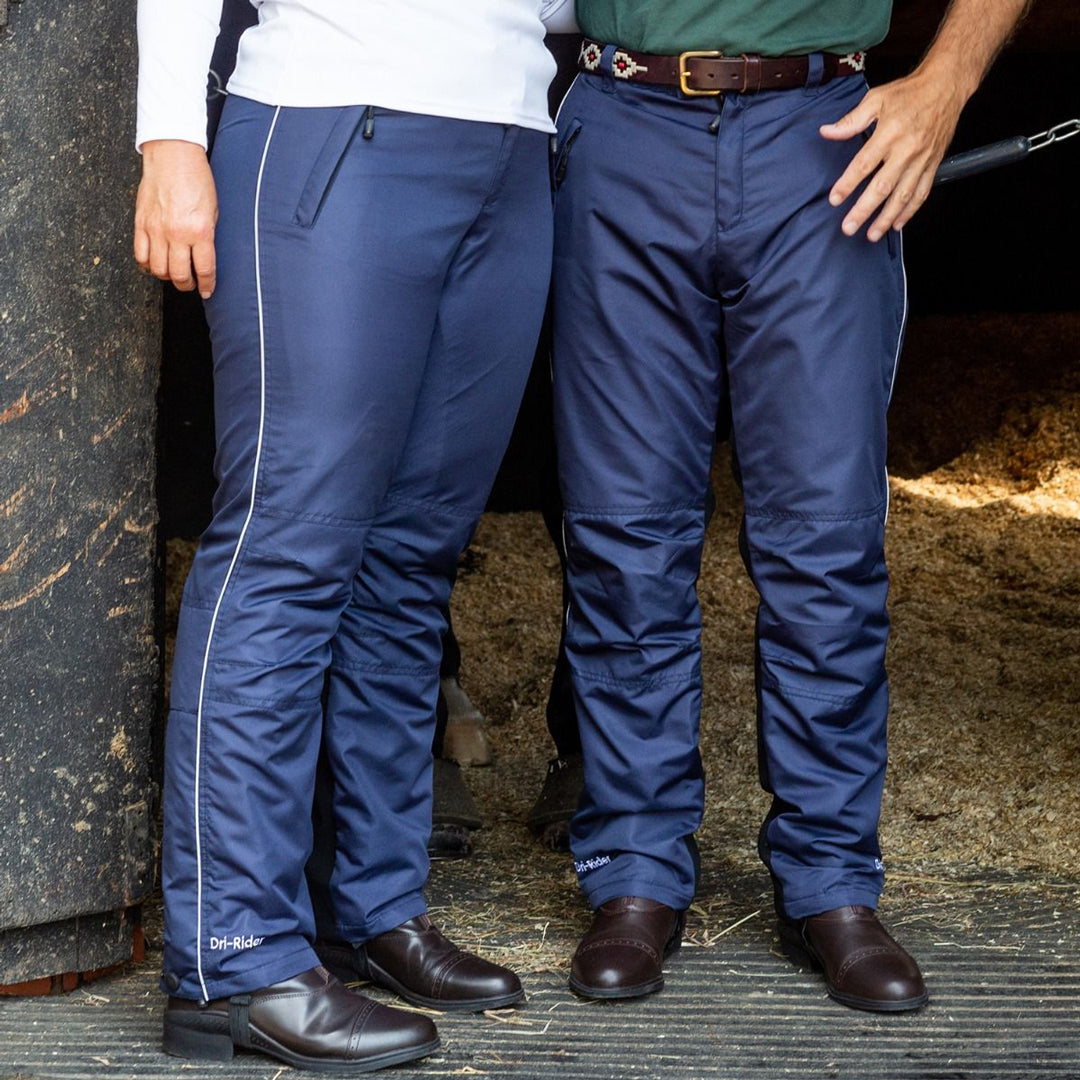 Man and woman pose in their Just chaps waterproof riding trousers