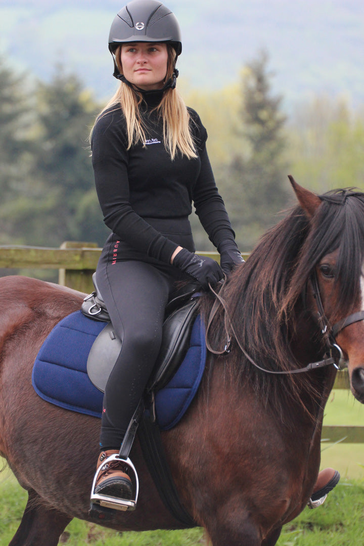 Rider wears the Keela x horsebackisbetter Merino Wool baselayer whilst riding